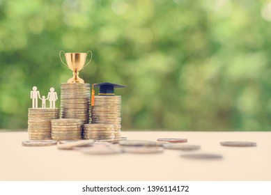 Saving For Child Education, Financial Concept : Golden Trophy Cup, Black Graduation Cap, Family Members With A Kid On Rows Of Rising Coins, Depict Money Or Asset Arrangement For Learning And Knowledge