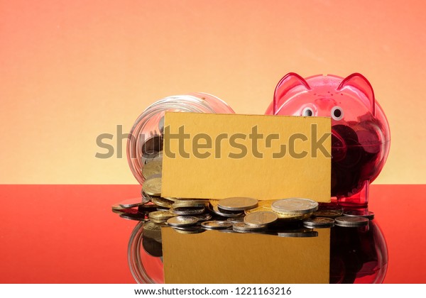 SAVING
CONCEPT: A red piggy bank on a orange
background.