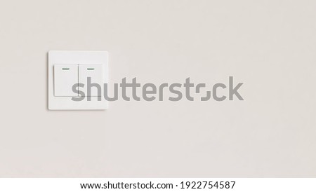 Saving energy concept - Beautiful clean wall inside the room with a white light power switch.  Environmental, Turn off light, Sustainable living, Home, Copy space.