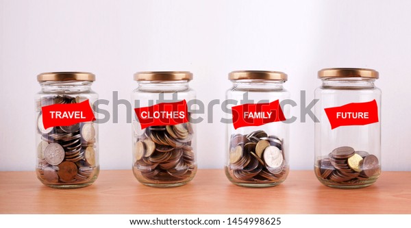 Saving for future planning concept with coin in\
glass jar on wooden\
table.