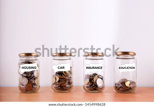 Saving for future planning concept with coin in\
glass jar on wooden\
table.