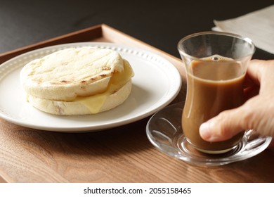 Saving A Glass Of Coffee And Cheese In English Muffin On The Table