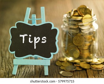 saving jar full of coin and a mini blackboard with text-tips
