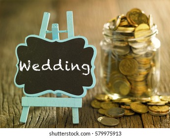 saving jar full of coin and a mini blackboard with text-wedding - Shutterstock ID 579975913