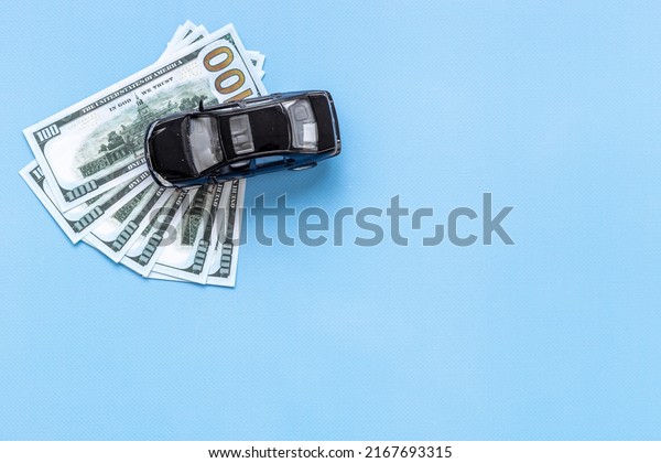 Saving money\
to buy a car. Toy car with money\
cash