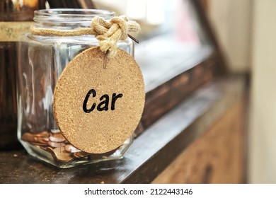 Saving Money For Buy Car. Vintage Retro Glass Jar With Hemp Rope Tie Car Tag And Few Coins Inside On Wood Counter. Spending On Down Payment Interest. Tips Help Lower Interest Rate And Monthly Payments