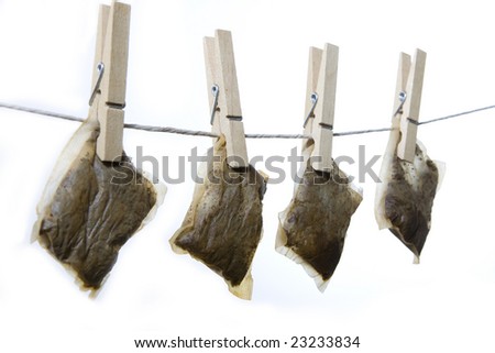 Saving money by drying and reusing teabags.