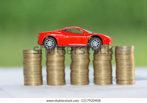 Saving money for car that stack gold coin\
growing ,saving money or money growth\
concept.