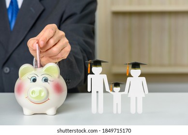 Saving money for child education, financial concept : Donor put money in a piggybank or donation box, parents and son wear black graduation cap on a table, depicts deposit money for student / children