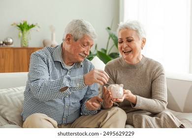 Saving money investment for future. Senior adult mature couple holding piggy bank putting money coin. Old man woman counting saving money planning retirement budget. Saving investment banking concept