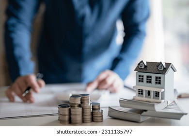 Saving money for new home. planning savings money of coins to buy a house concept for property. - Shutterstock ID 2311135797