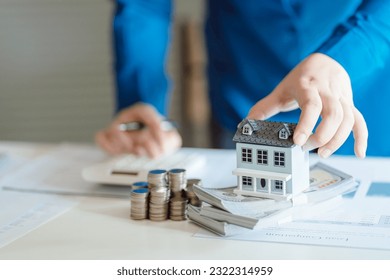 Saving money for Real estate investment with with stack of money coins for buying home and loan for prepare in the future financial insurance concept - Shutterstock ID 2322314959