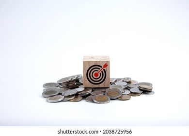 Saving Money. Setting Financial Goals For Interest Growth And Capital Gains. Pile Of Coins And Wooden Blocks With Bullseye Icon. With Copy Space And Business Design