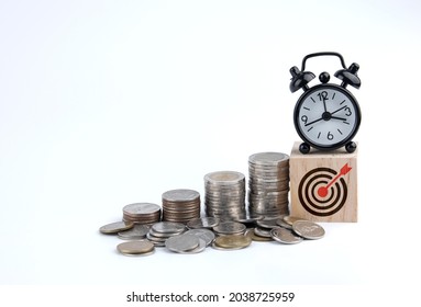 Saving Money. Setting Financial Goals For Interest Growth And Capital Gains. Pile Of Coins And Wooden Blocks With Bullseye Icon. With Copy Space And Business Design