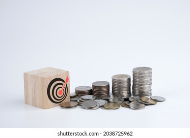 Saving Money. Setting Financial Goals For Interest Growth And Capital Gains. Pile Of Coins And Wooden Blocks With Bullseye Icon. With Copy Space And Business Design