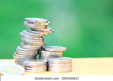 Saving money, Stack of coins money on natural green background