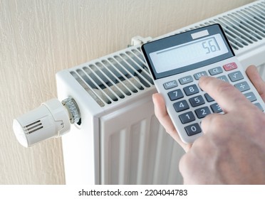 Saving Natural Gas And Energy Efficiency At Home. Home Heating Costs. Hands With Calculator Consider Cost Of Heating In Cold Season