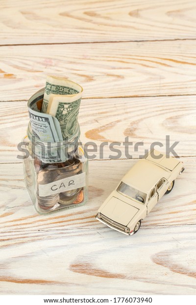 Savings for car in\
glass jar and small car\
toy