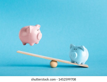 Savings Concept. Comparison Of Two Variants Of Investing Money With Piggy Banks On Blue Background, Copy Space