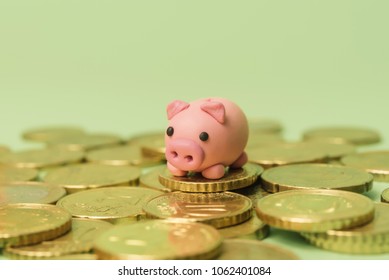 Savings Concept. Micro Piggy Bank On Top Of Coins. Money Concept. Saving For Vacation. Home Finance Concept.