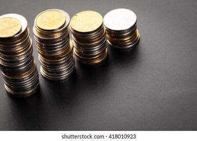 Savings, increasing columns of coins isolated on white background