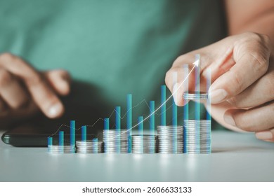 Savings and Investment concept. Saving money for finance accounting to arrange coins into the growing graph. Businessman holding a coin putting on stack coins. Chart for profit financial investment.