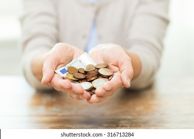 Savings, Money, Annuity Insurance, Retirement And People Concept - Close Up Of Senior Woman Hands Holding Money Jar