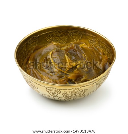 Savon beldi in a decorated metal cup isolated on white background