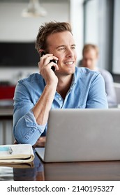 Savoring His Success. Shot Of A Man Talking On His Cellphone In A Casual Work Environment.