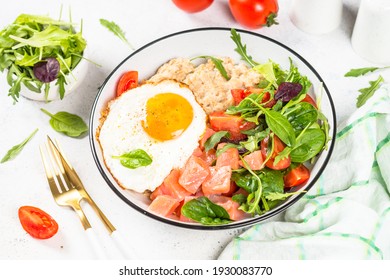 Savory Breakfast At White. Oatmeal Porrige With Salted Salmon, Egg And Fresh Salad.