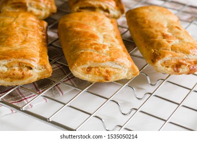 Savory Cheese And Onion Puff Pastry Rolls Fresh Out Of The Oven Cooling On A Cooking Trivet A Vegetarian Alternative To The Usual Sausage Roll