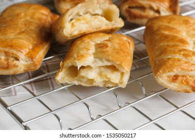 Savory Cheese And Onion Puff Pastry Rolls Fresh Out Of The Oven Cooling On A Cooking Trivet A Vegetarian Alternative To The Usual Sausage Roll