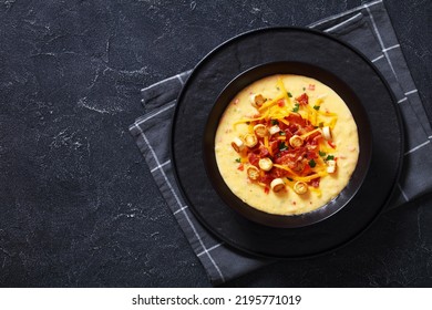 Savory Creamy Pumpkin Soup Topped With Fried Bacon, Shredded Cheddar Cheese And Salty Croutons In Black Bowl On Concrete Table, ,flat Lay, Free Space