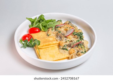 Savory crepe with creamy mushroom sauce, fresh greens on a white plate. Perfect for a light and satisfying meal. - Powered by Shutterstock