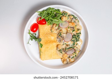 Savory crepe with creamy mushroom sauce, fresh greens on a white plate. Perfect for a light and satisfying meal. - Powered by Shutterstock