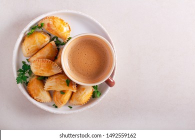 Savory Hand Pies On Plate With Coffee