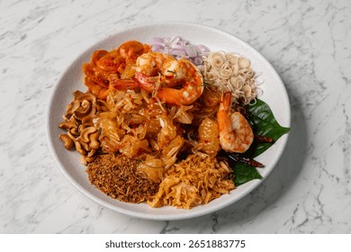 Savory shrimp paste fried rice served with sweet pork, dried shrimp, egg strips, fresh vegetables, and chili. A colorful and flavorful Thai dish.