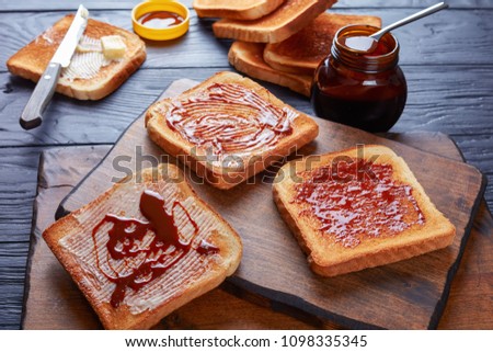 savory toasts for breakfast with butter vegemite - healthy food spread made from leftover brewers yeast extract with vegetables and spices, view from above, close-up