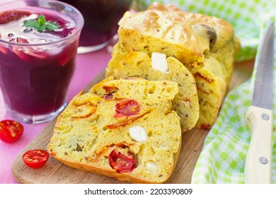 Savoury cake with curry, chorizo, cherry tomatoes, olives and feta cheese. Selective focus - Shutterstock ID 2203390809