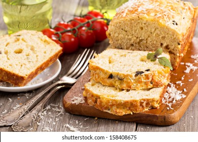 Savoury loaf cake with tomatoes, cheese and olives