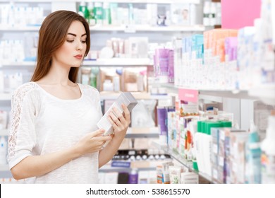 Savvy Shopper. Beautiful Young Woman Buying Medicine At The Local Pharmacy