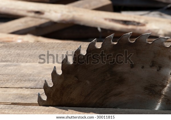 Saw blade and wood\
background
