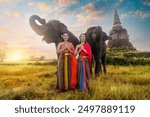 Sawasdee welcome to thailand Asia woman in Thai dress traditional enjoy with the elephants .Portrait women in traditional clothingl in Ayutthaya Thailand