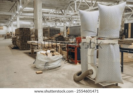 Sawdust extractor machine working in a carpentry workshop, filtering wood dust and shavings, ensuring a clean and safe working environment