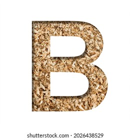 Sawdust Wood Font. The Letter B Cut Out Of Paper On The Background Of Sawdust Or Small Shavings Of A Fruit Tree. Decorative Alphabet For Handmade Or Small Production, Font Collection.