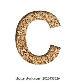 Sawdust Wood Font. The Letter C Cut Out Of Paper On The Background Of Sawdust Or Small Shavings Of A Fruit Tree. Decorative Alphabet For Handmade Or Small Production, Font Collection.