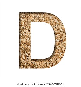 Sawdust Wood Font. The Letter D Cut Out Of Paper On The Background Of Sawdust Or Small Shavings Of A Fruit Tree. Decorative Alphabet For Handmade Or Small Production, Font Collection.