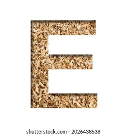 Sawdust Wood Font. The Letter E Cut Out Of Paper On The Background Of Sawdust Or Small Shavings Of A Fruit Tree. Decorative Alphabet For Handmade Or Small Production, Font Collection.