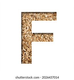 Sawdust Wood Font. The Letter F Cut Out Of Paper On The Background Of Sawdust Or Small Shavings Of A Fruit Tree. Decorative Alphabet For Handmade Or Small Production, Font Collection.