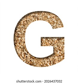 Sawdust Wood Font. The Letter G Cut Out Of Paper On The Background Of Sawdust Or Small Shavings Of A Fruit Tree. Decorative Alphabet For Handmade Or Small Production, Font Collection.